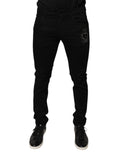 Jeans skinny en denim coton noir Dolce & Gabbana avec logo couronne DG sur la poche arrière, détails modernes et élégants.