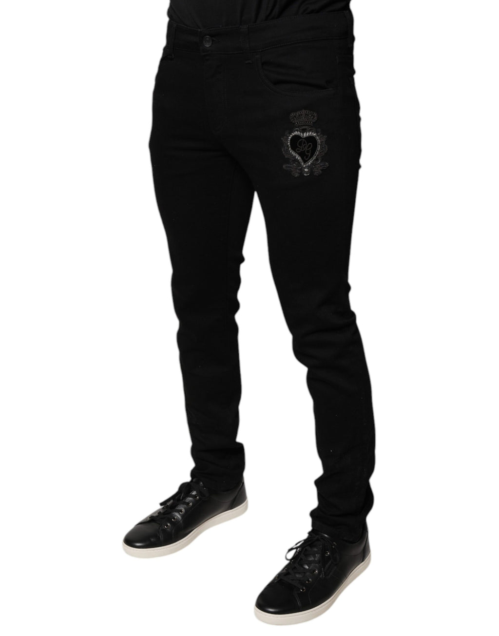 Jean skinny en denim coton noir Dolce & Gabbana avec logo couronne DG visible à l'avant.