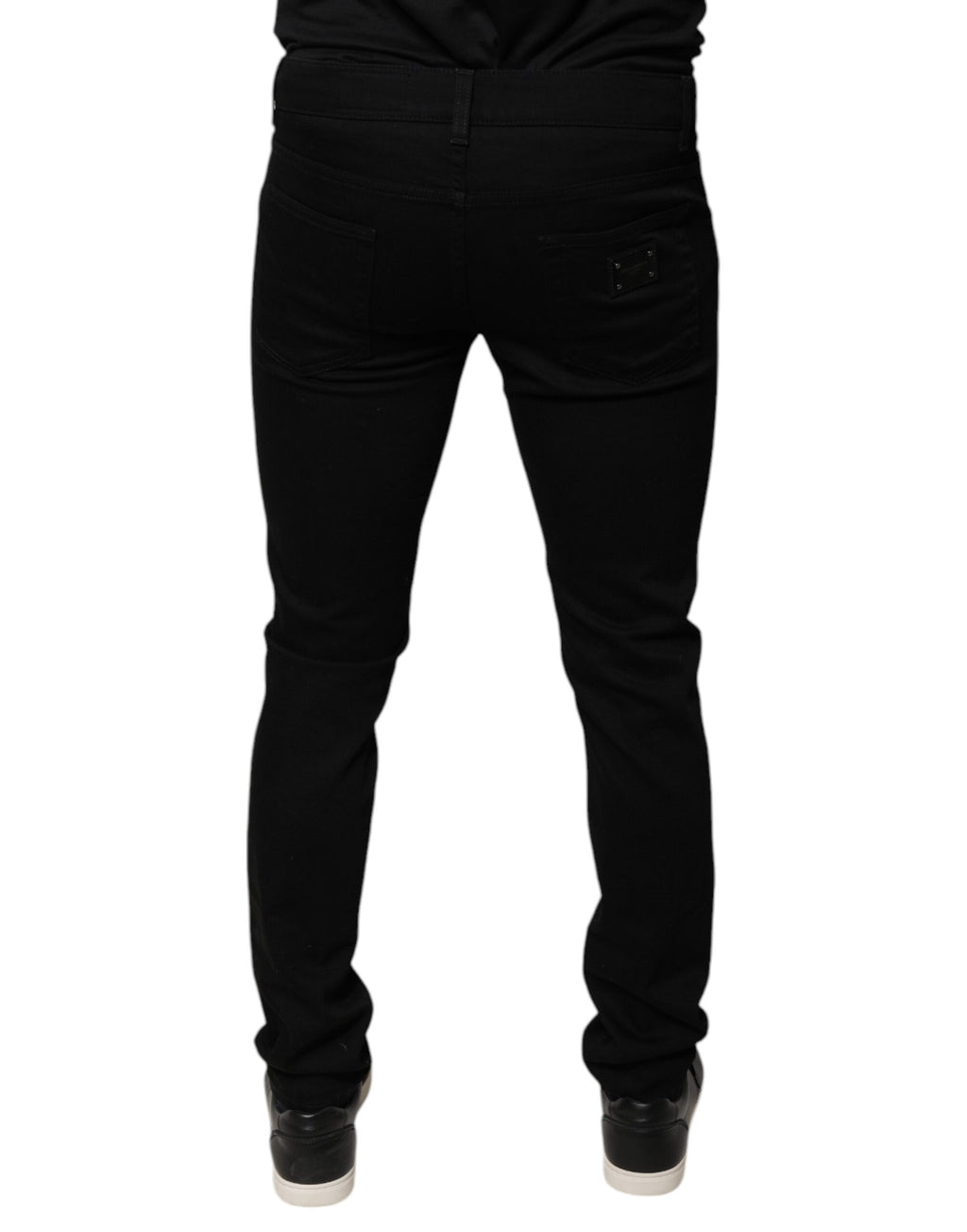 Jeans skinny en denim coton noir Dolce & Gabbana avec logo couronne DG visible sur la poche arrière.