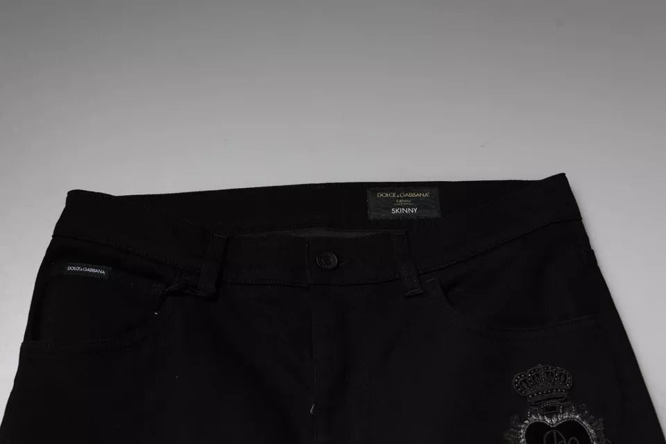 Jeans skinny en denim coton noir Dolce & Gabbana avec logo couronne DG visible sur le devant.