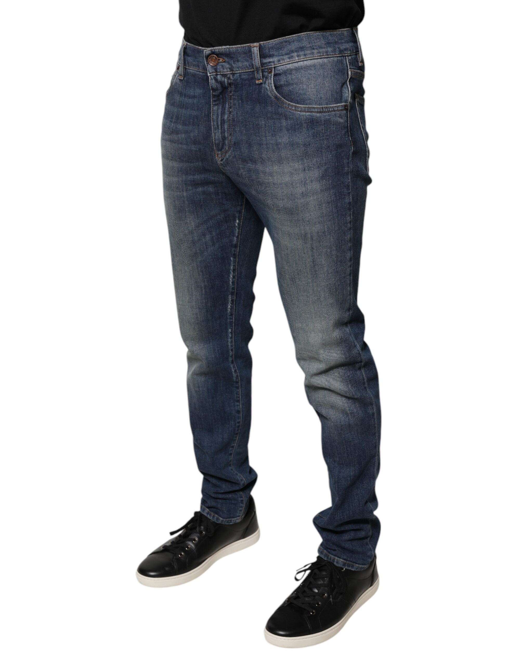 Jeans skinny en coton bleu Dolce & Gabbana avec logo couronne DG, visible sur l'image.