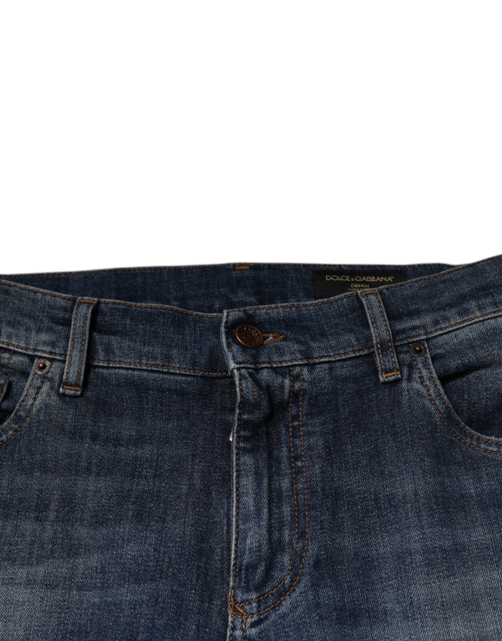 Jeans skinny en denim coton bleu Dolce & Gabbana avec logo DG couronne, vue de face avec détails visibles.