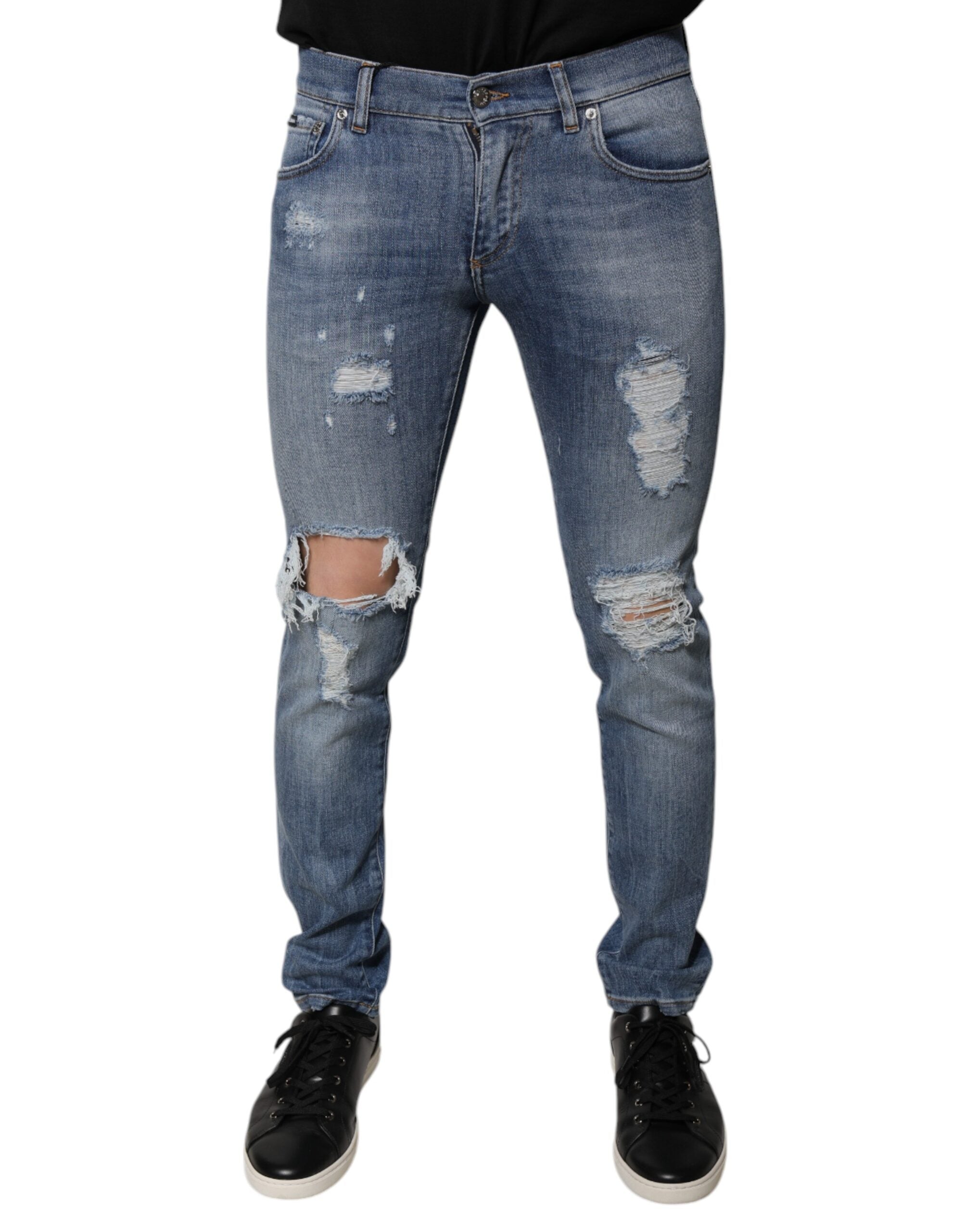 Jeans skinny en denim coton extensible bleu déchiré de Dolce & Gabbana, style tattered, coupe ajustée, détails décontractés.