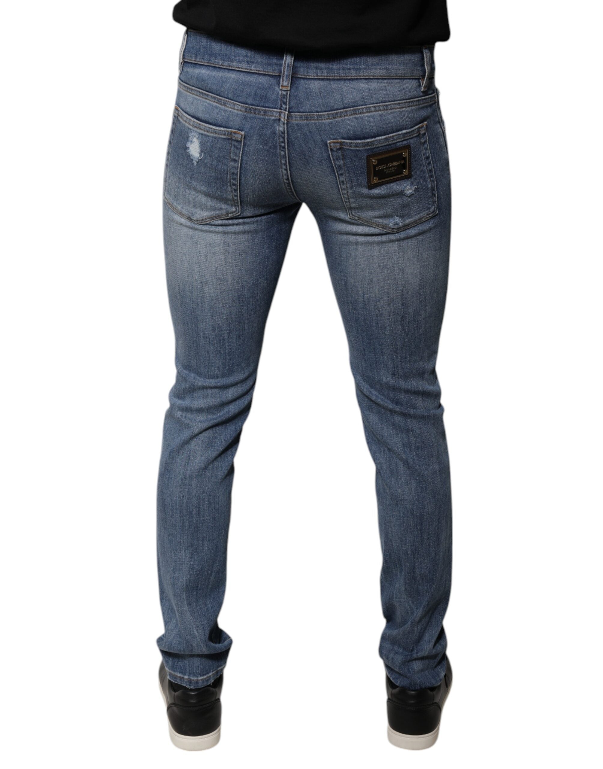 Jeans skinny en coton déchiré bleu Dolce & Gabbana, coupe stretch, style décontracté avec détails usés visibles.