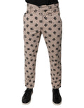 Jeans skinny en coton beige avec logo Dolce & Gabbana, détails en denim, coupe ajustée et style élégant.