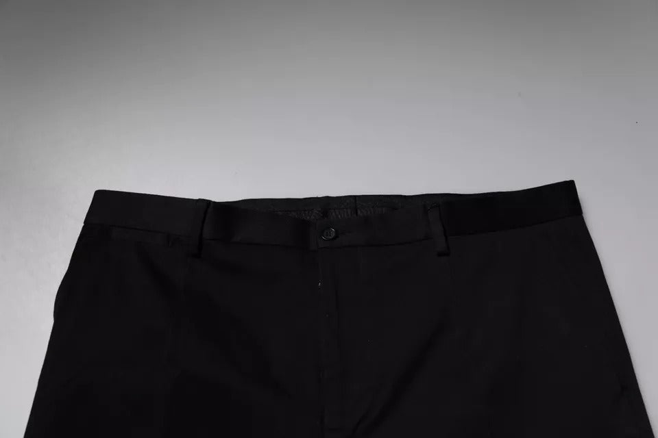 Pantalon de costume noir Dolce & Gabbana à coupe fuselée, élégant et formel, en tissu lisse avec ceinture assortie.