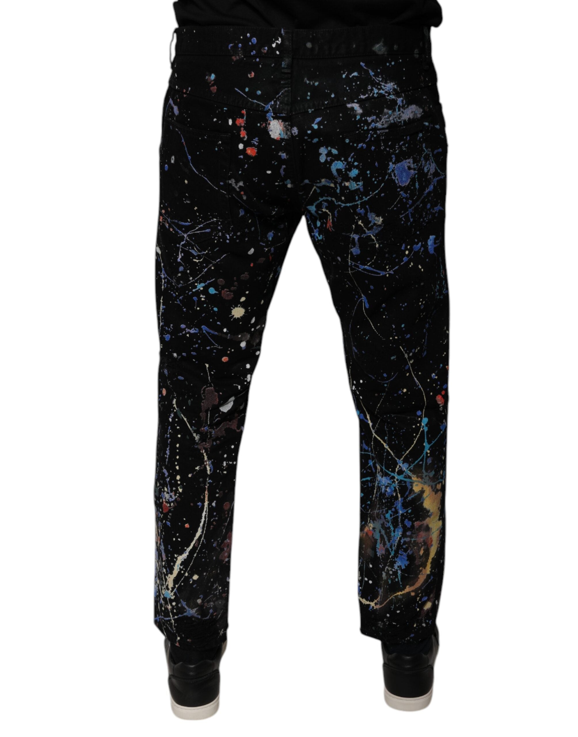 Jeans skinny en denim coton noir avec éclaboussures de couleur de Dolce & Gabbana, détails modernes et style élégant.