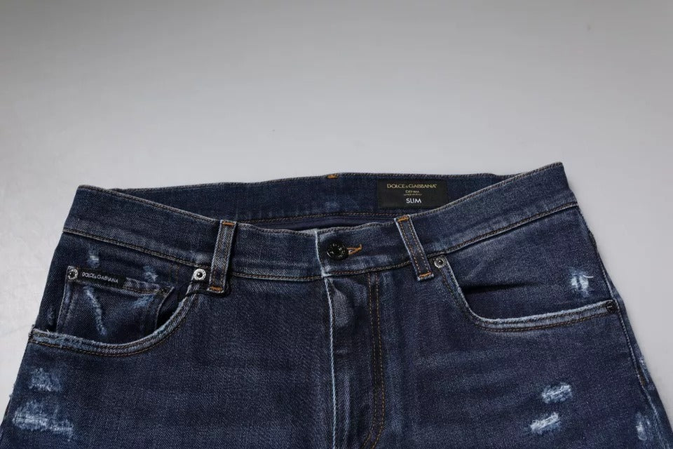 Jeans skinny en denim coton bleu foncé Dolce & Gabbana avec logo, vue de face, détails visibles.