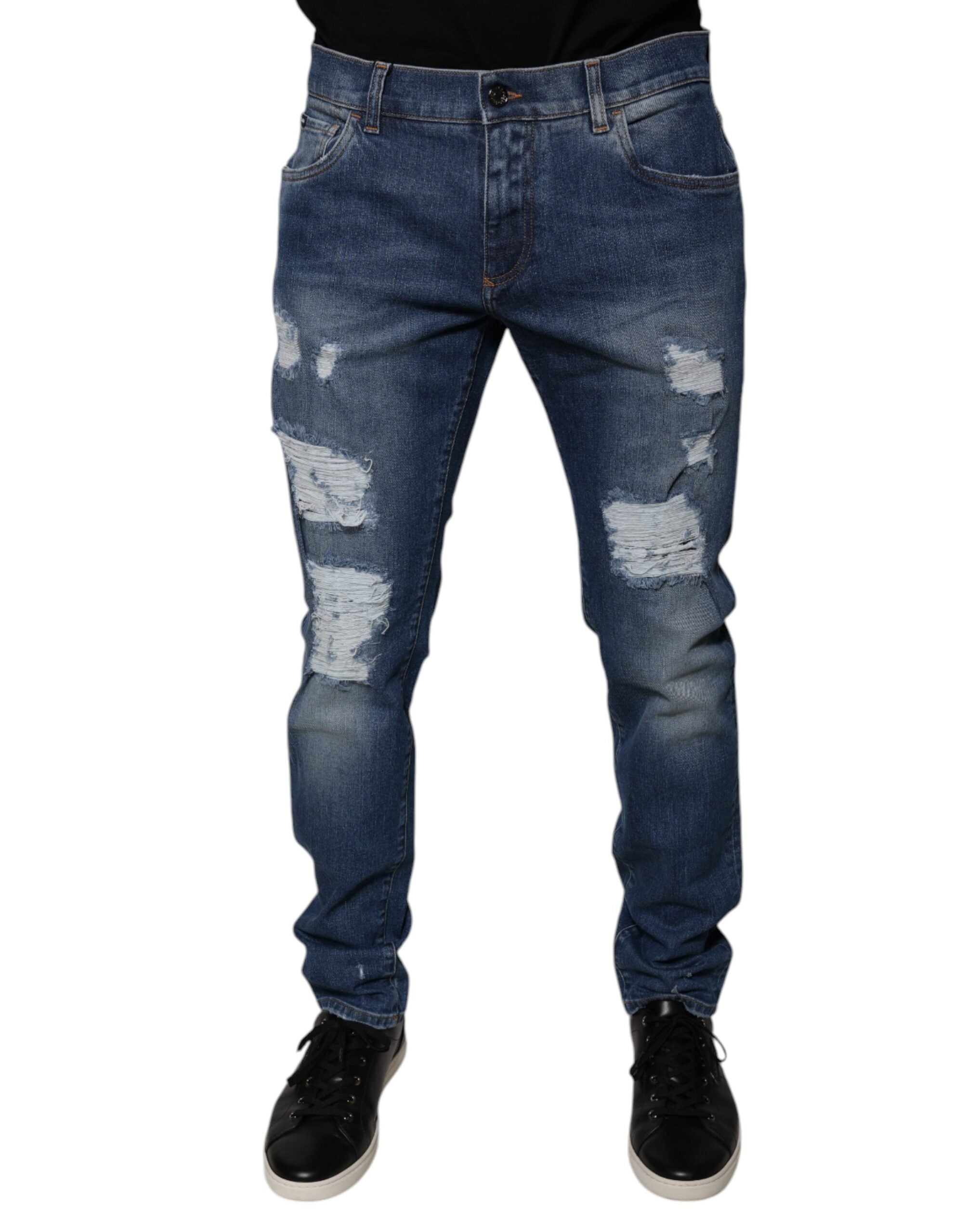 Jeans skinny en denim bleu déchiré de Dolce & Gabbana en coton, avec un style usé et détails déchirés visibles.