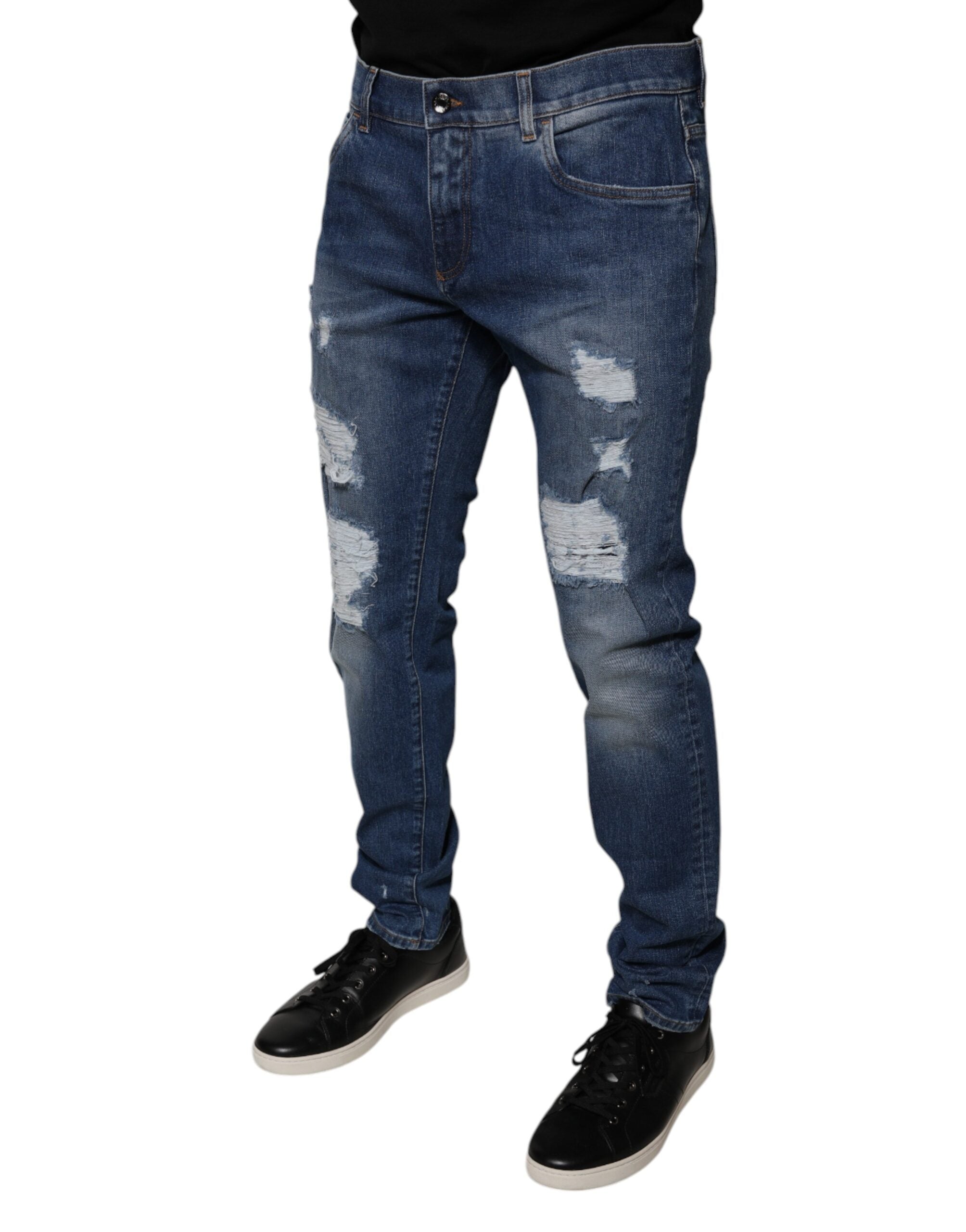 Jeans skinny en denim bleu tissé avec déchirures, de la marque Dolce & Gabbana, en coton, vue en gros plan.