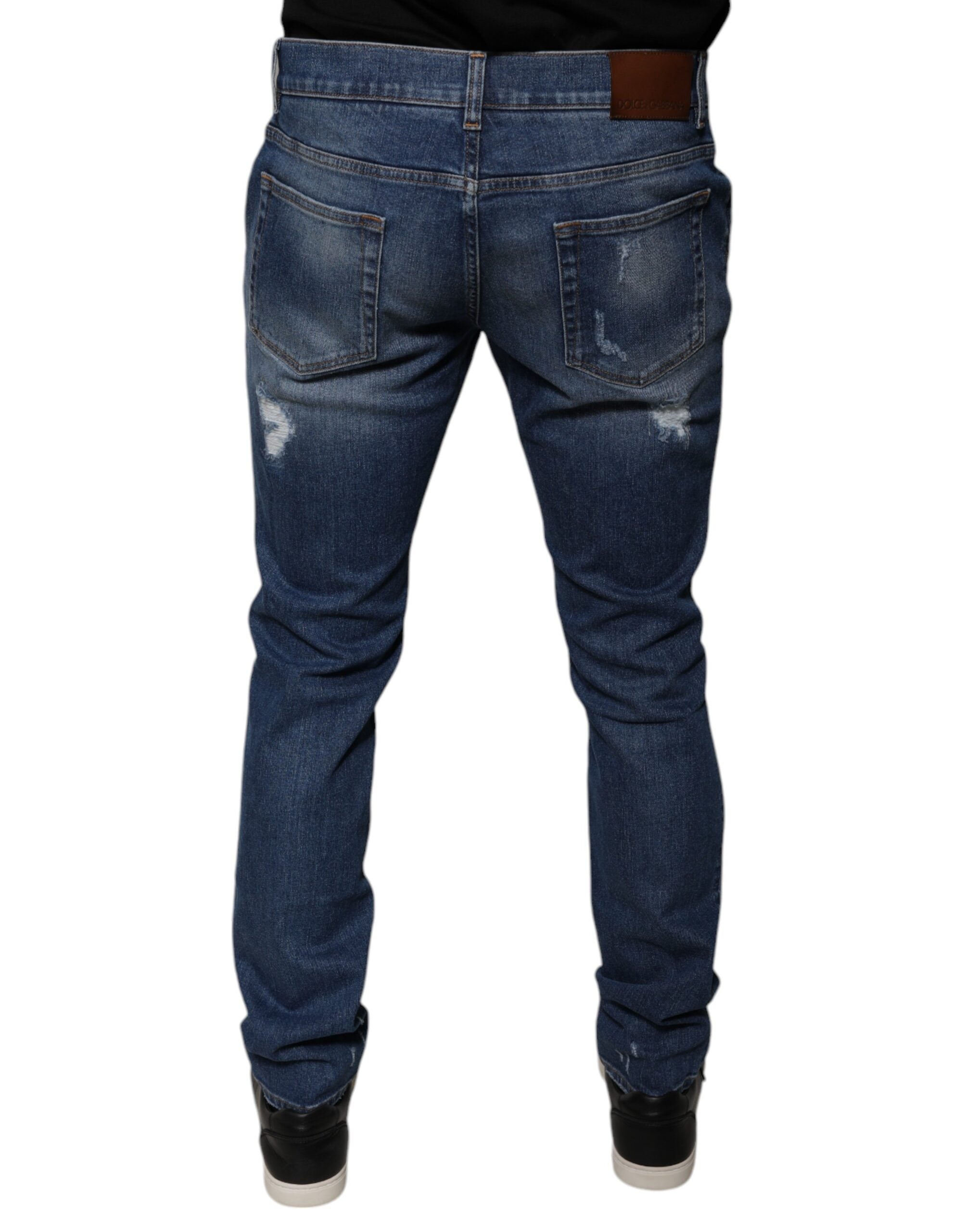 Jeans skinny en denim déchiré bleu en coton de Dolce & Gabbana, style tendance et moderne.