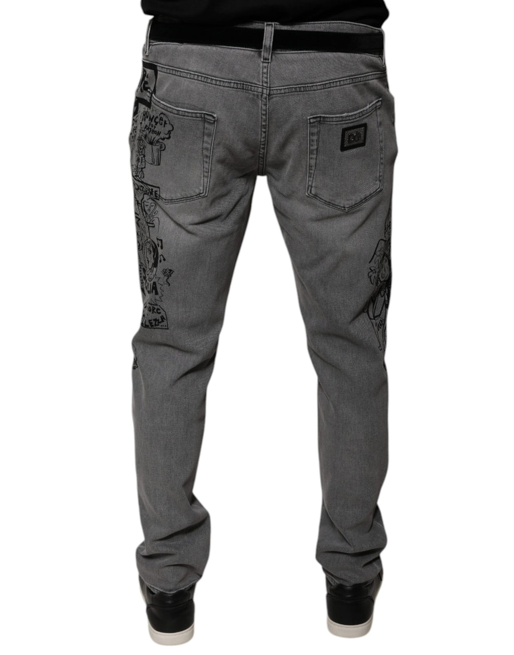 Jeans skinny en denim gris à imprimé graphique en coton de Dolce & Gabbana, visibles avec détails de la couture et coupe ajustée.