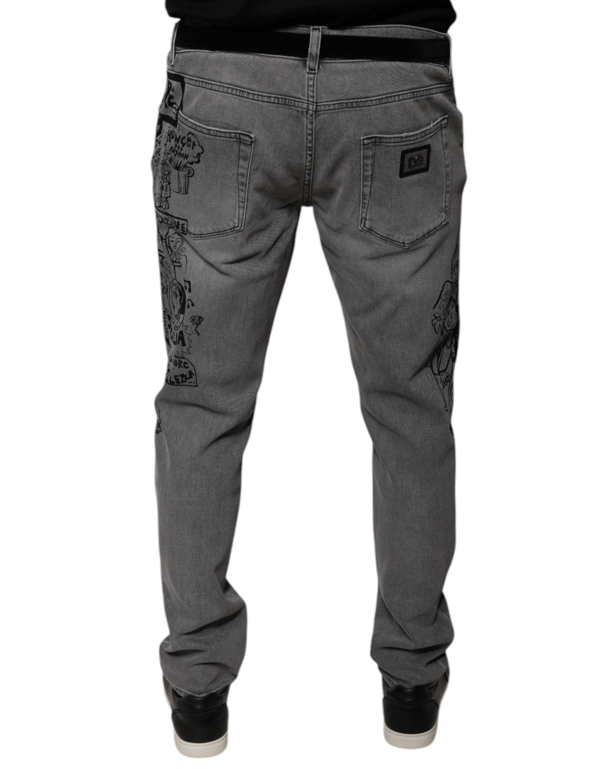 Jeans skinny en denim gris à imprimé graphique en coton de Dolce & Gabbana, visibles avec détails de la couture et coupe ajustée.