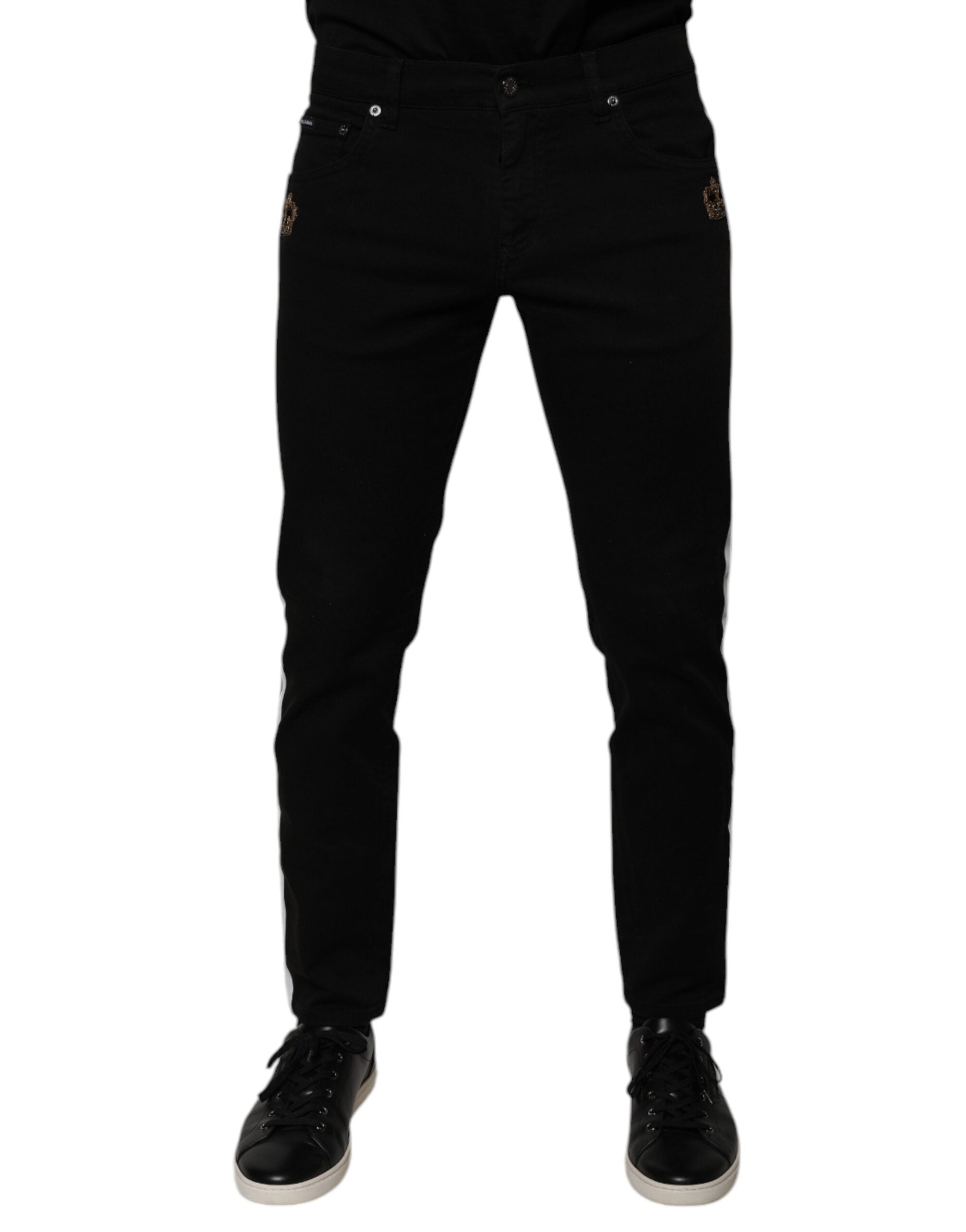 Jean slim Dolce & Gabbana noir avec doublure blanche et motif couronne, en denim skinny pour un style élégant et moderne.