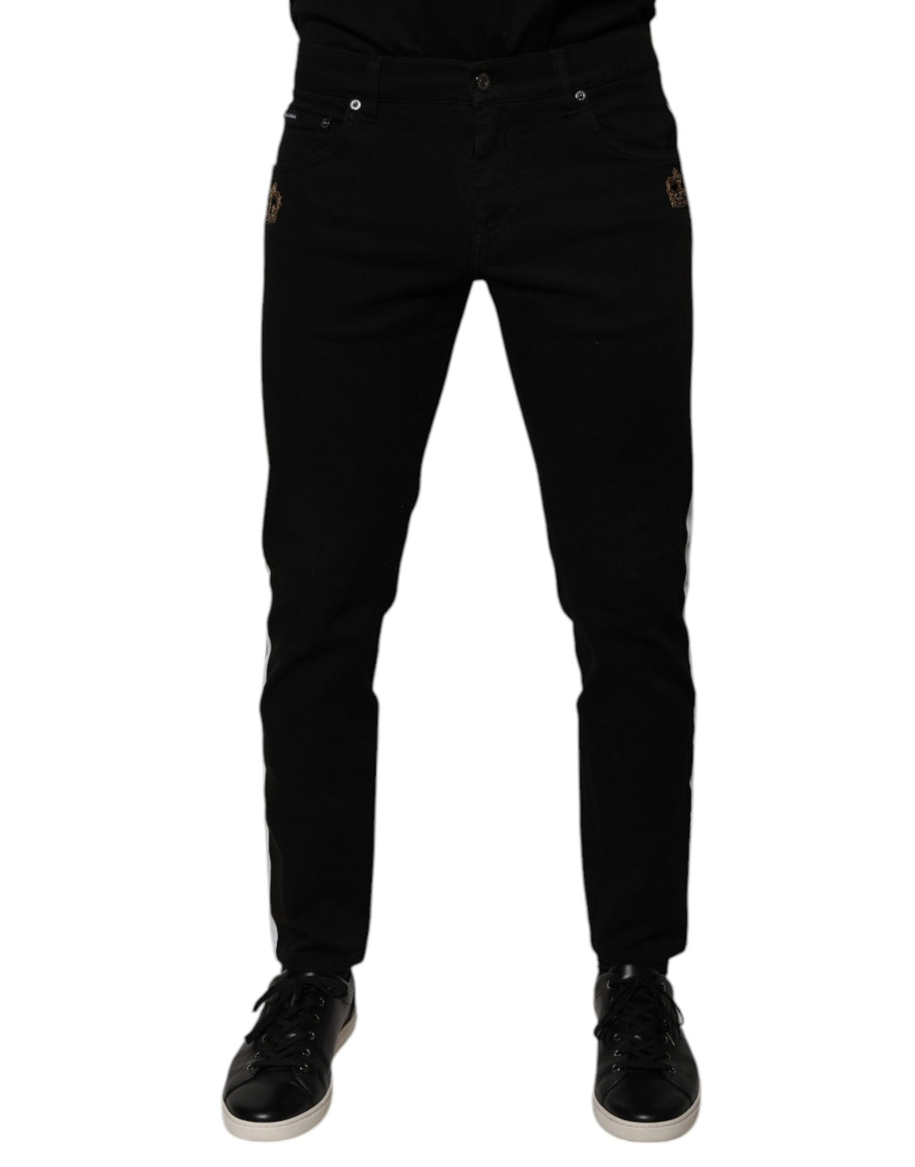 Jeans skinny en denim noir Dolce & Gabbana avec doublure blanche et motif de couronne, vue de face.