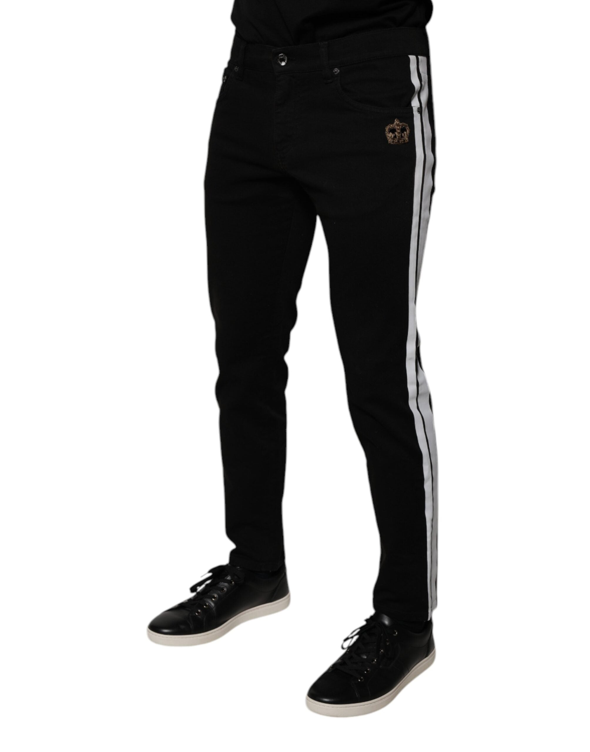 Jeans skinny en denim noir avec doublure blanche et motif couronne de Dolce & Gabbana, style élégant et moderne.