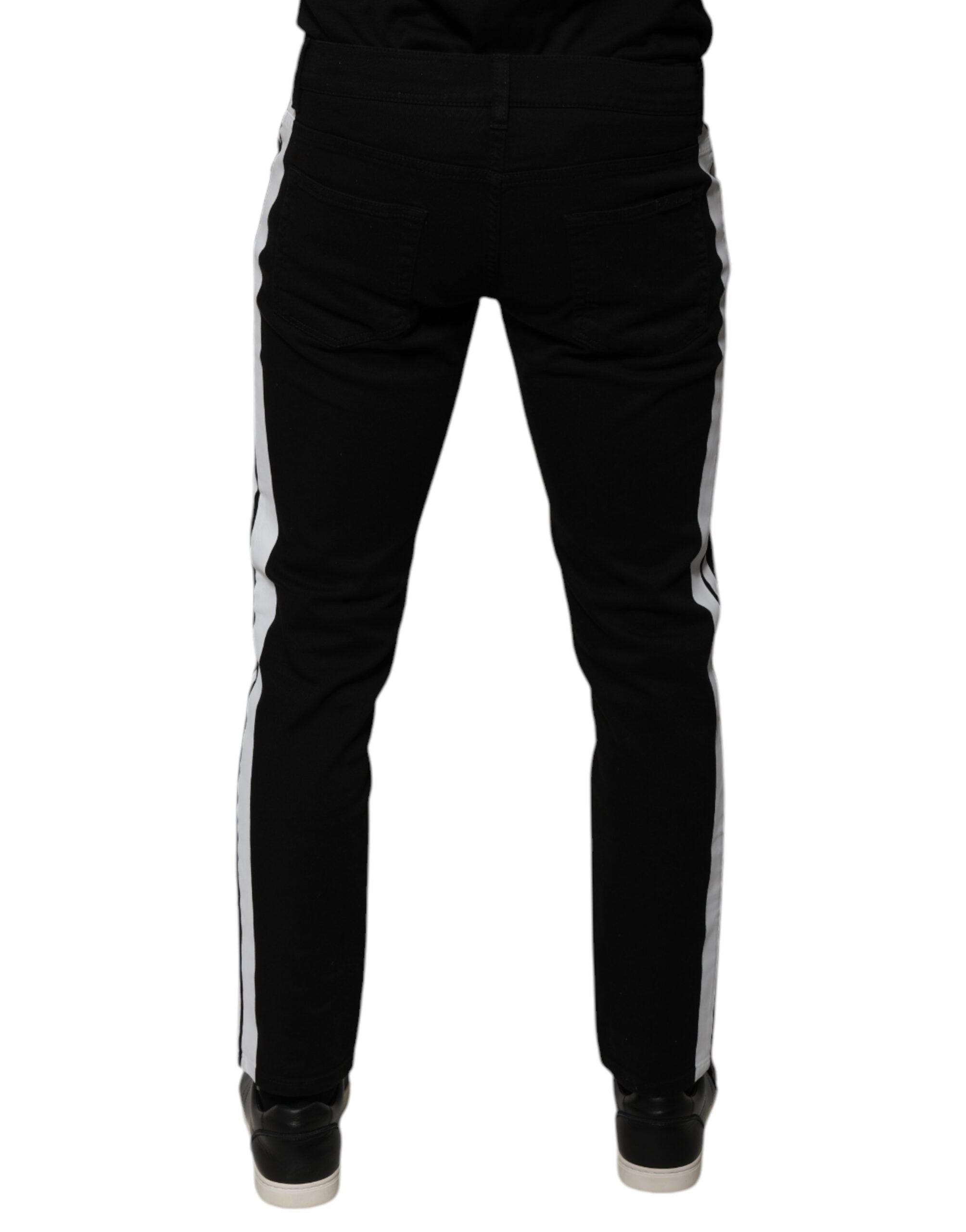 Jeans skinny Dolce & Gabbana noirs avec doublure blanche et motif couronne, visible devant, en denim de style élégant.