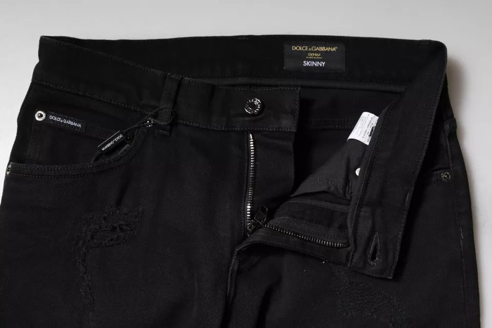 Jeans skinny en denim noir Dolce & Gabbana avec déchirures et logo, en coton, mode tendance et élégante.
