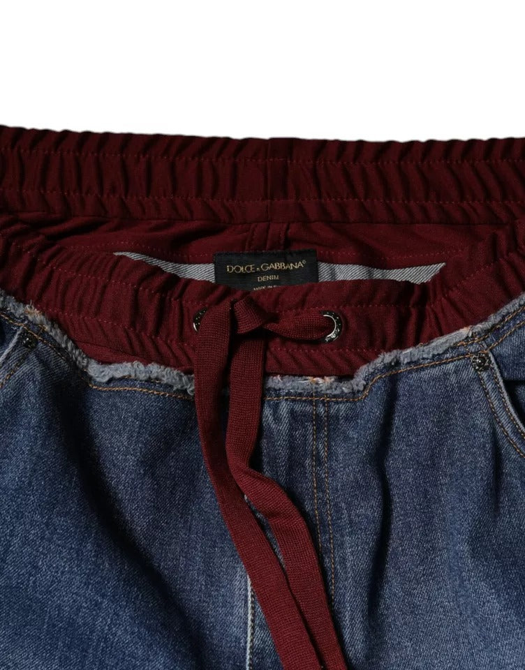 Jeans droits en denim stretch bleu Dolce & Gabbana en coton, visible avec détails de couture et poche arrière.