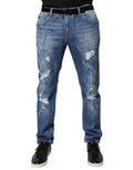 Jeans skinny déchirés en coton stretch bleu Dolce & Gabbana, style tattered, ajustés avec détails usés.