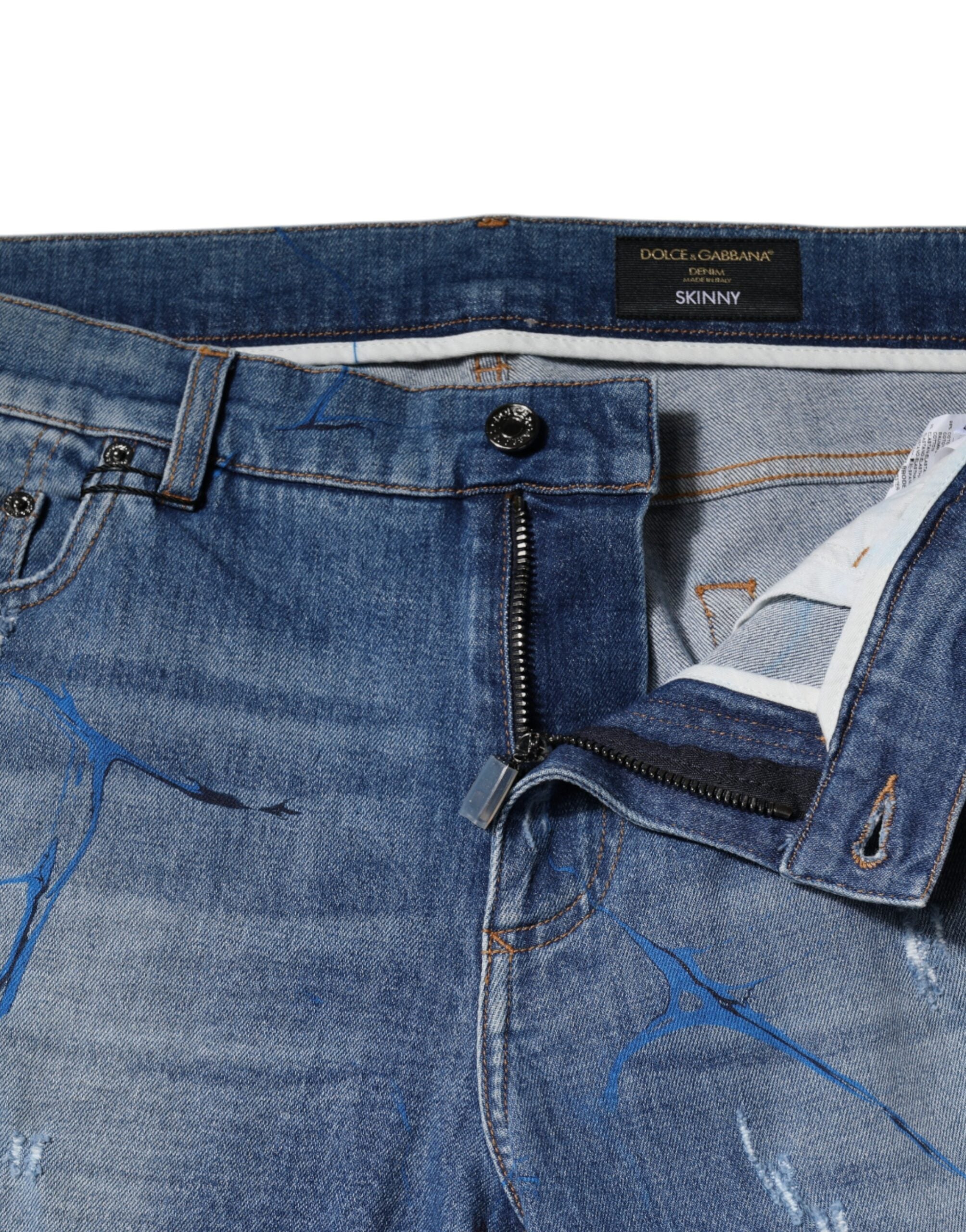 Jeans slim en denim coton extensible bleu tacheté Dolce & Gabbana, style décontracté avec déchirures.