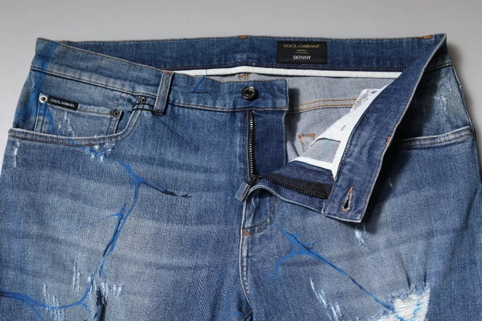 Jeans skinny en denim tissé extensible bleu Dolce & Gabbana avec déchirures et style usé, vue de face sur un fond neutre.