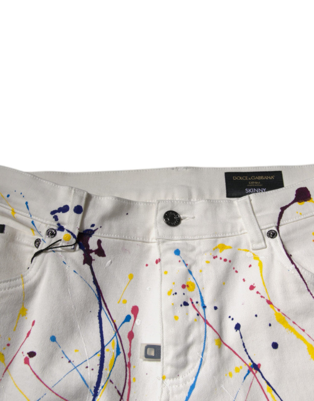 Jeans skinny en denim blanc avec imprimé éclaboussure de couleurs Dolce & Gabbana, style moderne et tendance.