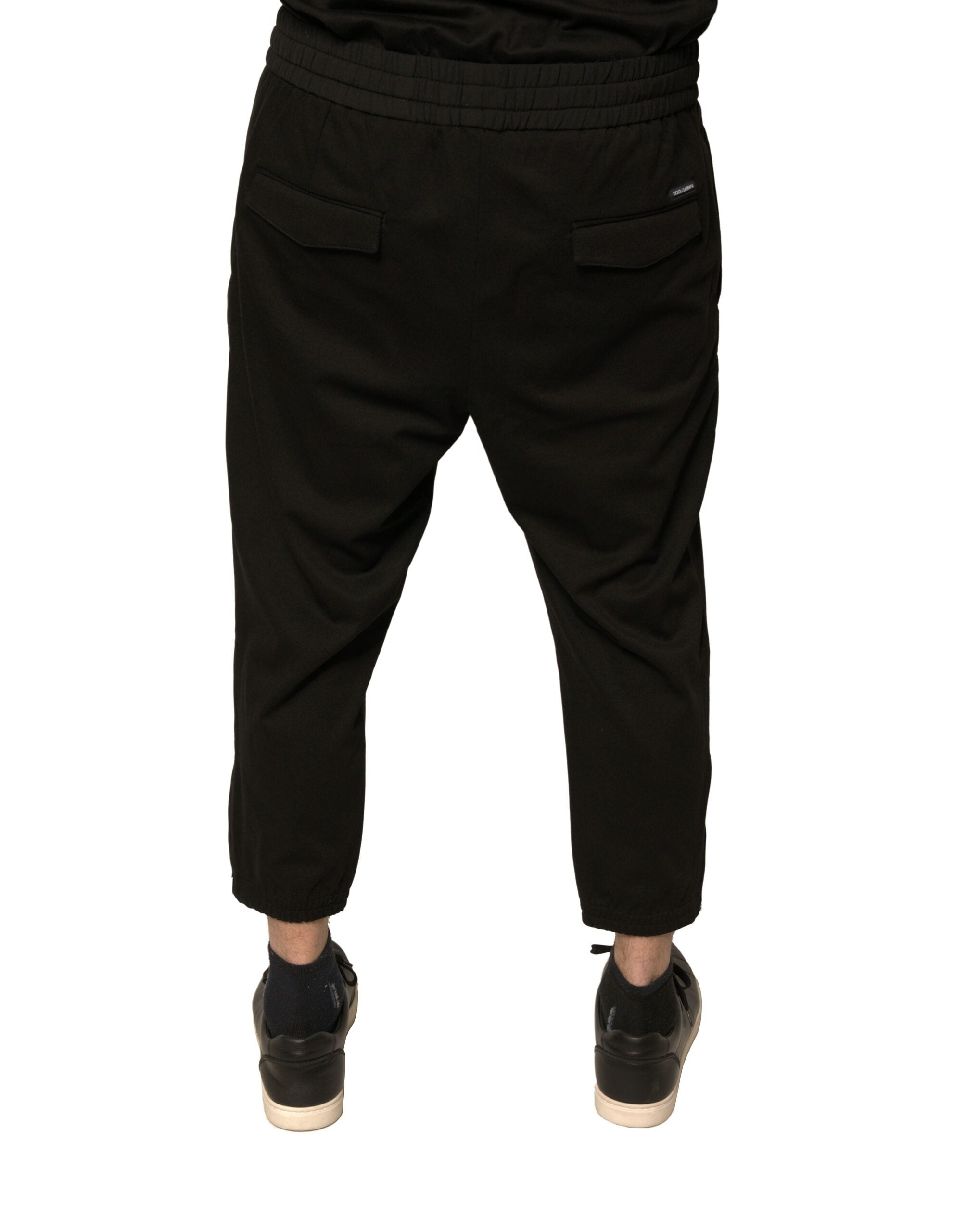 Pantalons jogging Dolce & Gabbana en laine noire, style décontracté et élégant, visibles avec détails de couture et ceinture élastique.