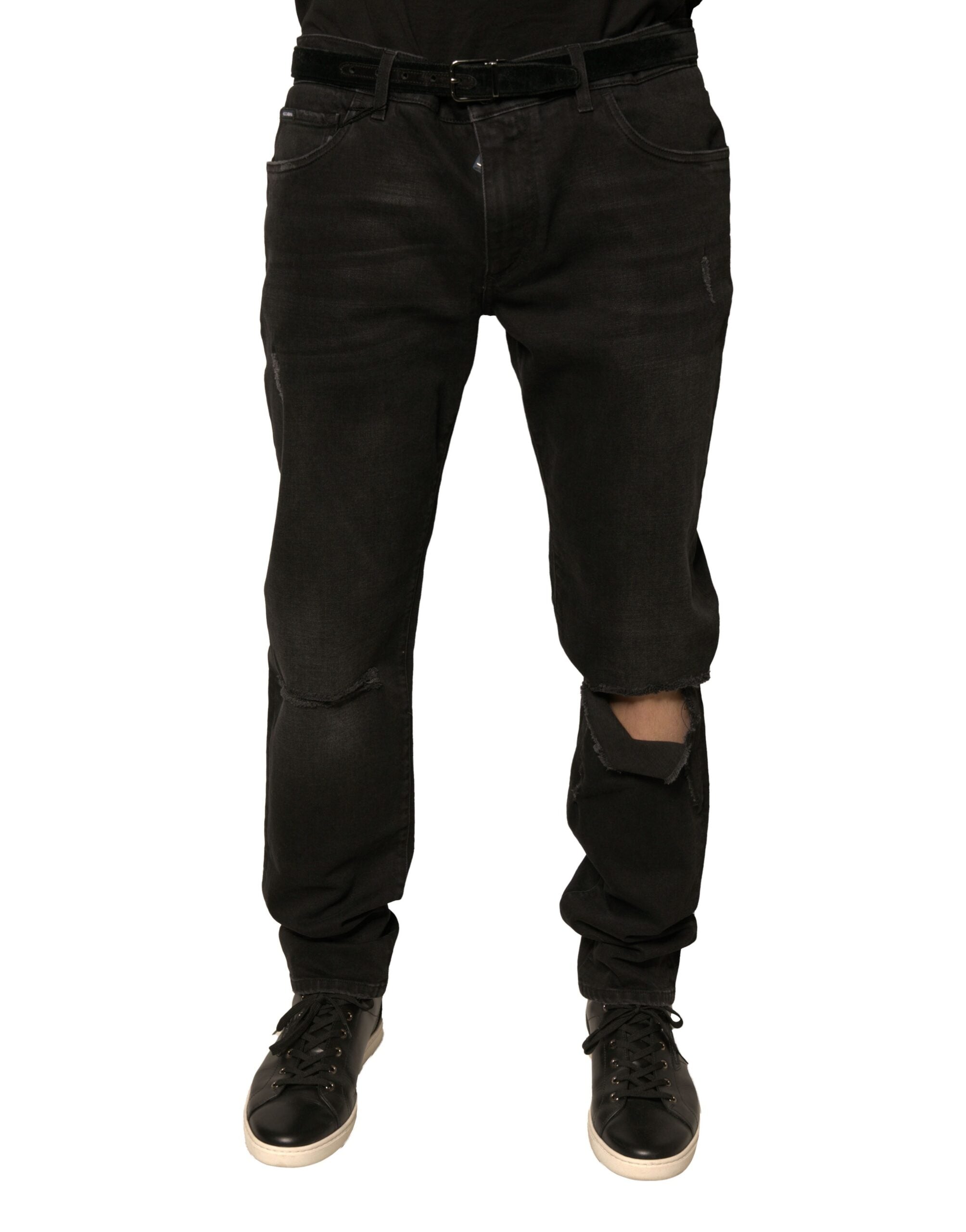 Jeans skinny en denim coton noir Dolce & Gabbana avec logo déchiré et détails usés visibles sur l'image.