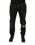 Jeans skinny en denim noir Dolce & Gabbana avec déchirures, logo brodé, coupe ajustée et détails modernes.