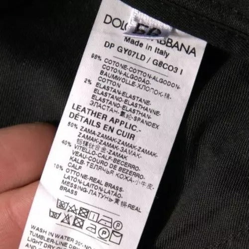 Jeans skinny en denim noir Dolce & Gabbana avec déchirures, logo brodé et coupe ajustée.