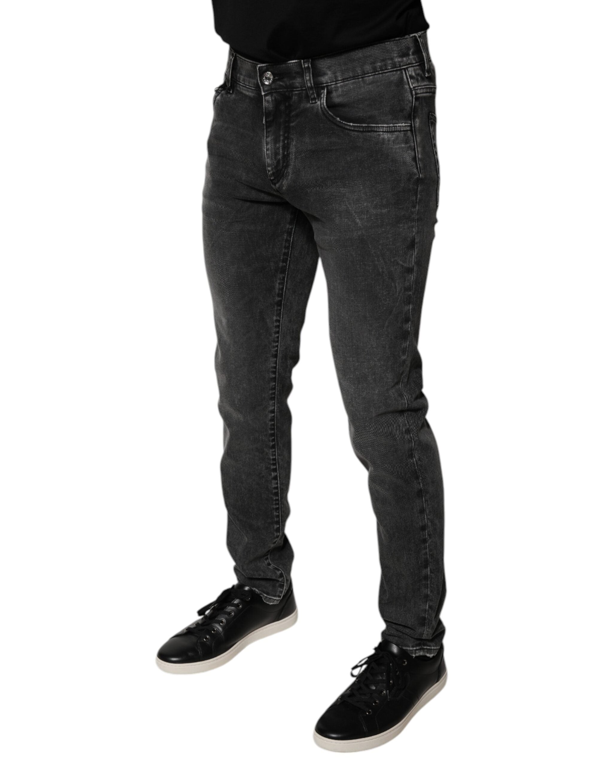 Pantalons skinny en denim stretch noir Dolce & Gabbana avec logo en coton, vue de face sur fond neutre.