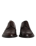 Chaussures de ville Derby wingtip en cuir marron de Dolce & Gabbana, lacets et finition élégante pour tenue formelle.