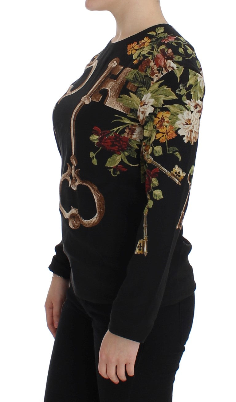 Blouse en soie noire Dolce & Gabbana avec motifs floraux clés, top élégant et féminin, détails visibles sur l'image.