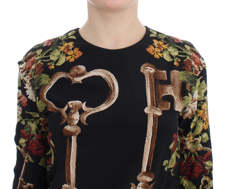 Chemisier en soie noir de Dolce & Gabbana avec motif floral clé, élégant et féminin, visible en détail dans l'image.