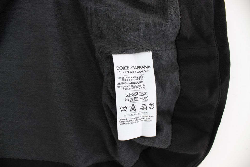 Chemisier en soie noir Dolce & Gabbana avec imprimé floral clé, élégant haut à manches longues et coupe fluide.
