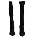 Bottes noires en daim Dolce & Gabbana, cuissardes à talons stilettos, élégantes et sophistiquées, visibles en gros plan.