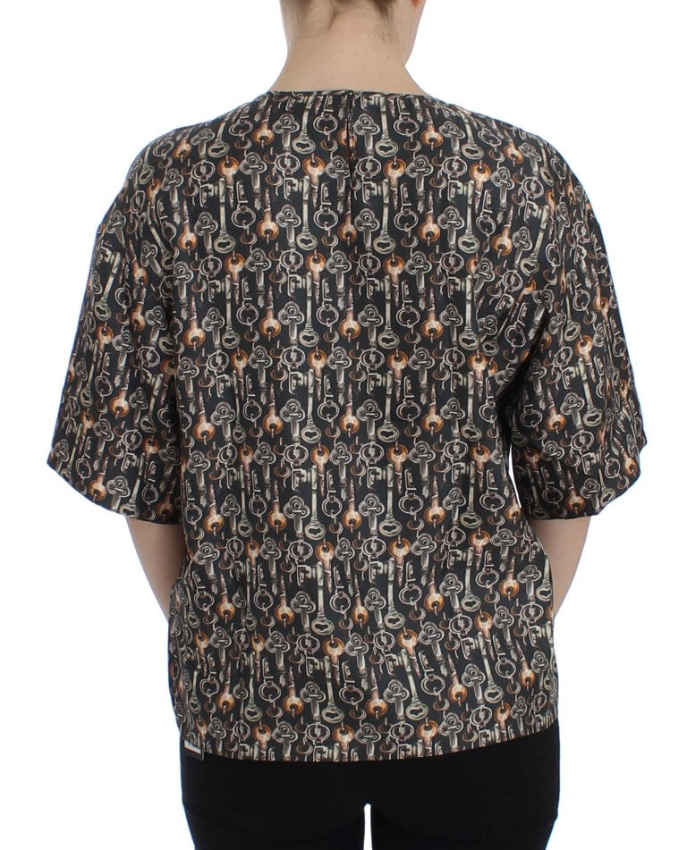 Blouse en soie Dolce & Gabbana gris or avec motif clé imprimé, style élégant et sophistiqué.
