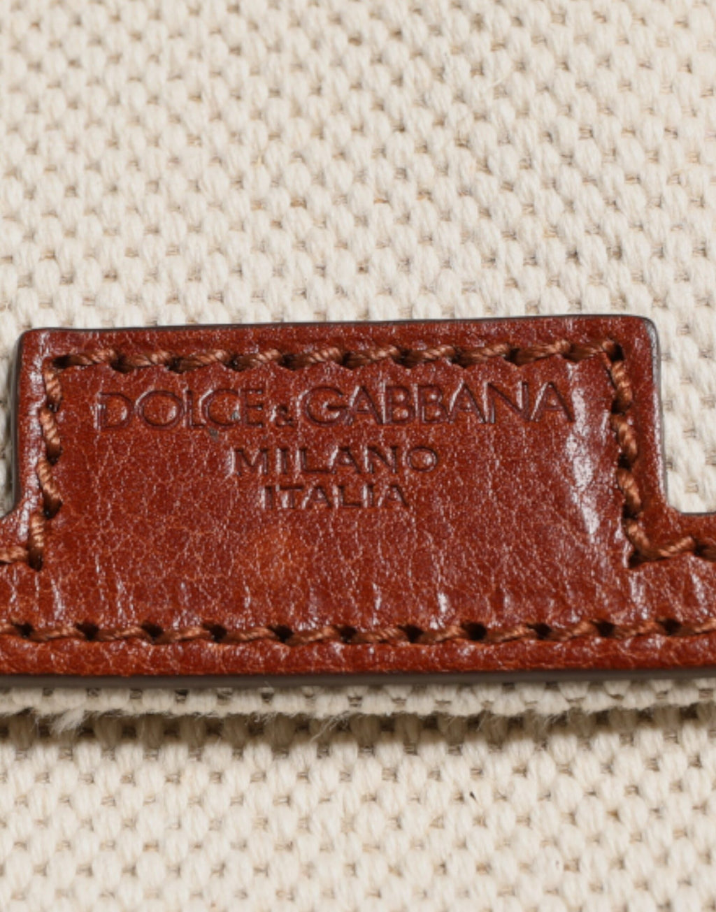Sac à dos pour homme Dolce & Gabbana en toile beige et marron avec détails en cuir, style élégant et pratique.