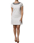 Robe courte en jacquard brocart blanc Dolce & Gabbana ornée de cristaux, élégance sophistiquée pour une tenue chic.