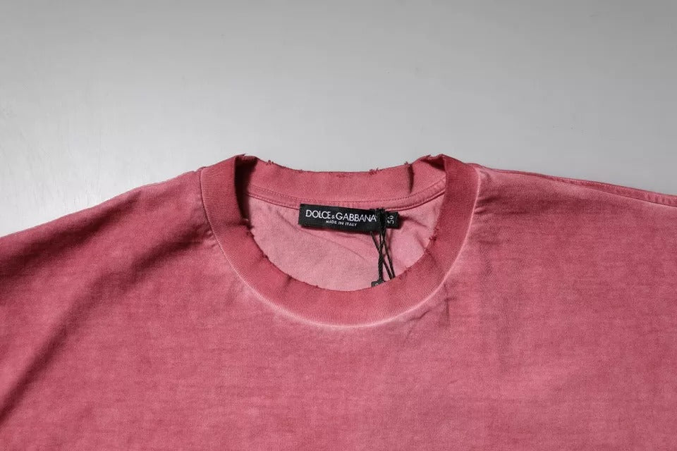 T-shirt en coton rose avec logo imprimé de Dolce & Gabbana, col rond et style décontracté, visible sur l'image.
