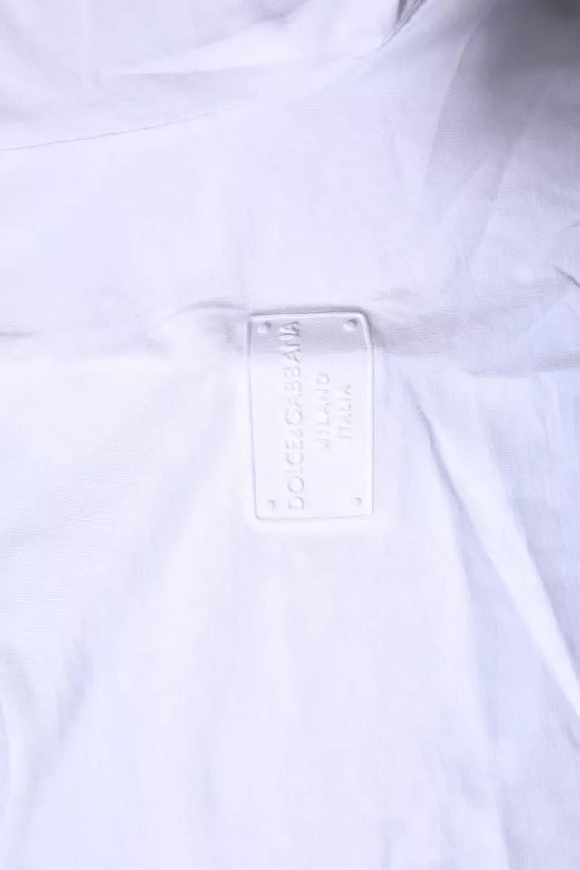 T-shirt blanc en coton Dolce & Gabbana avec logo en plaque, col rond et design élégant visible sur l'image.