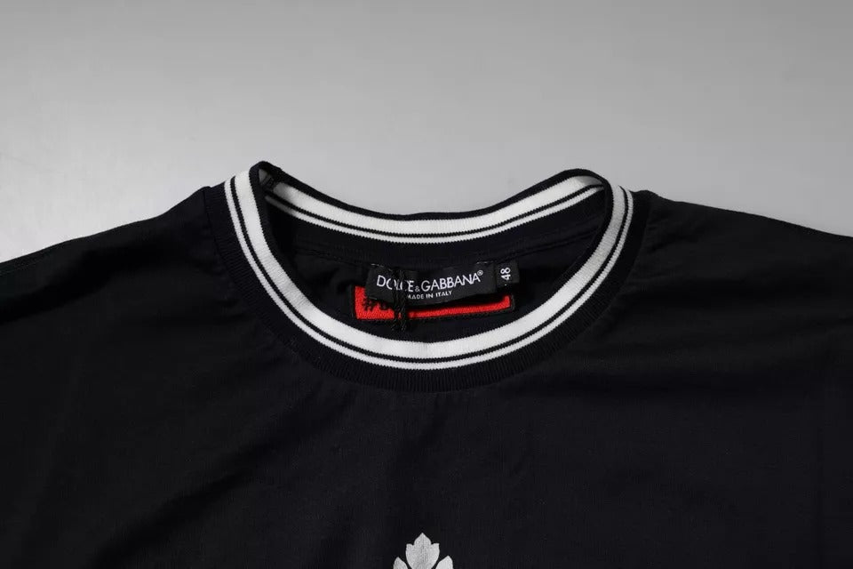 T-shirt en coton bleu foncé Dolce & Gabbana avec logo de couronne, col rond, style décontracté, visible sur l'image.