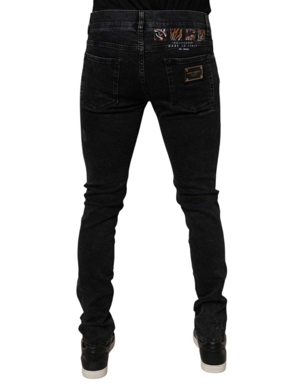 Jeans homme Dolce & Gabbana en denim noir déchiré, coupe skinny, en coton avec détails usés.