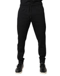 Pantalons de jogging en coton noir Dolce & Gabbana, coupe décontractée avec ceinture élastique et détails modernes.