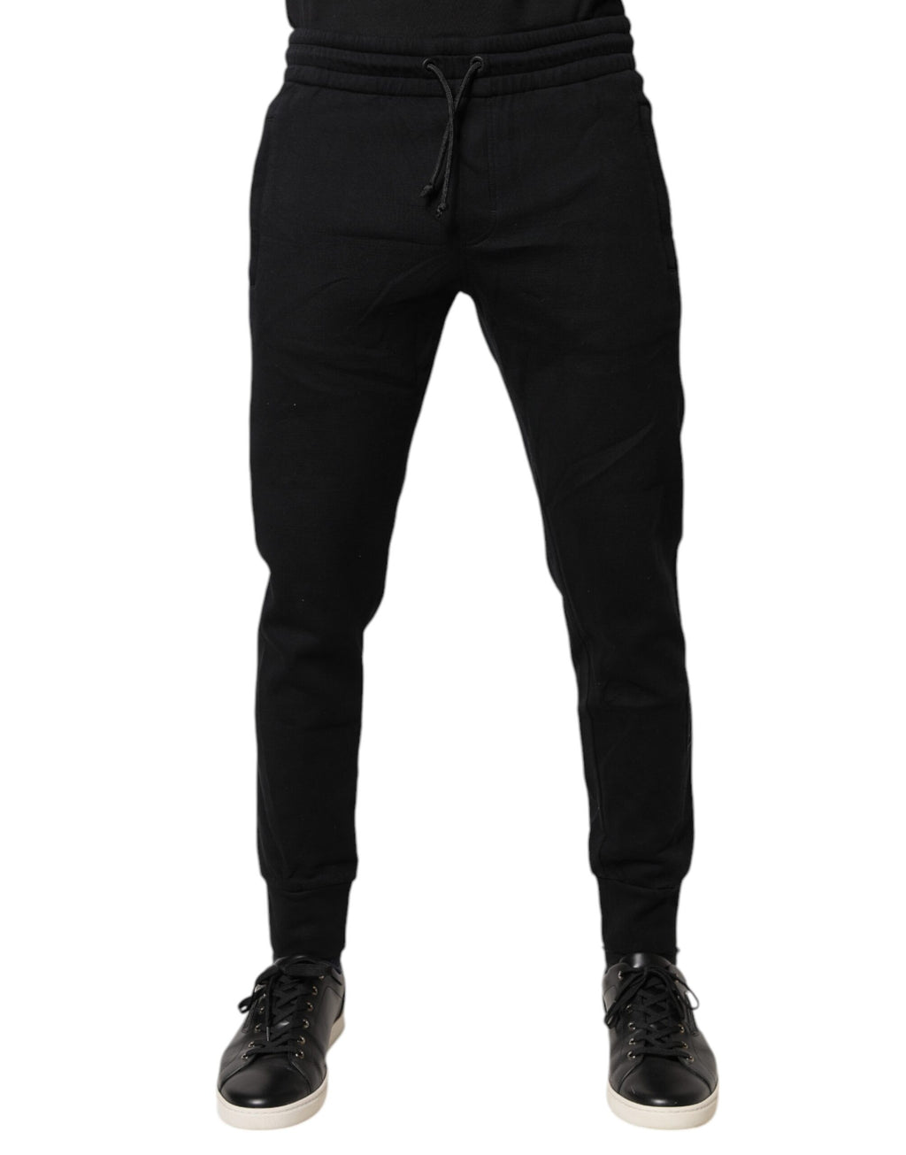 Pantalons de jogging noirs en coton Dolce & Gabbana, style décontracté avec logo discret, vue de face sur un mannequin.