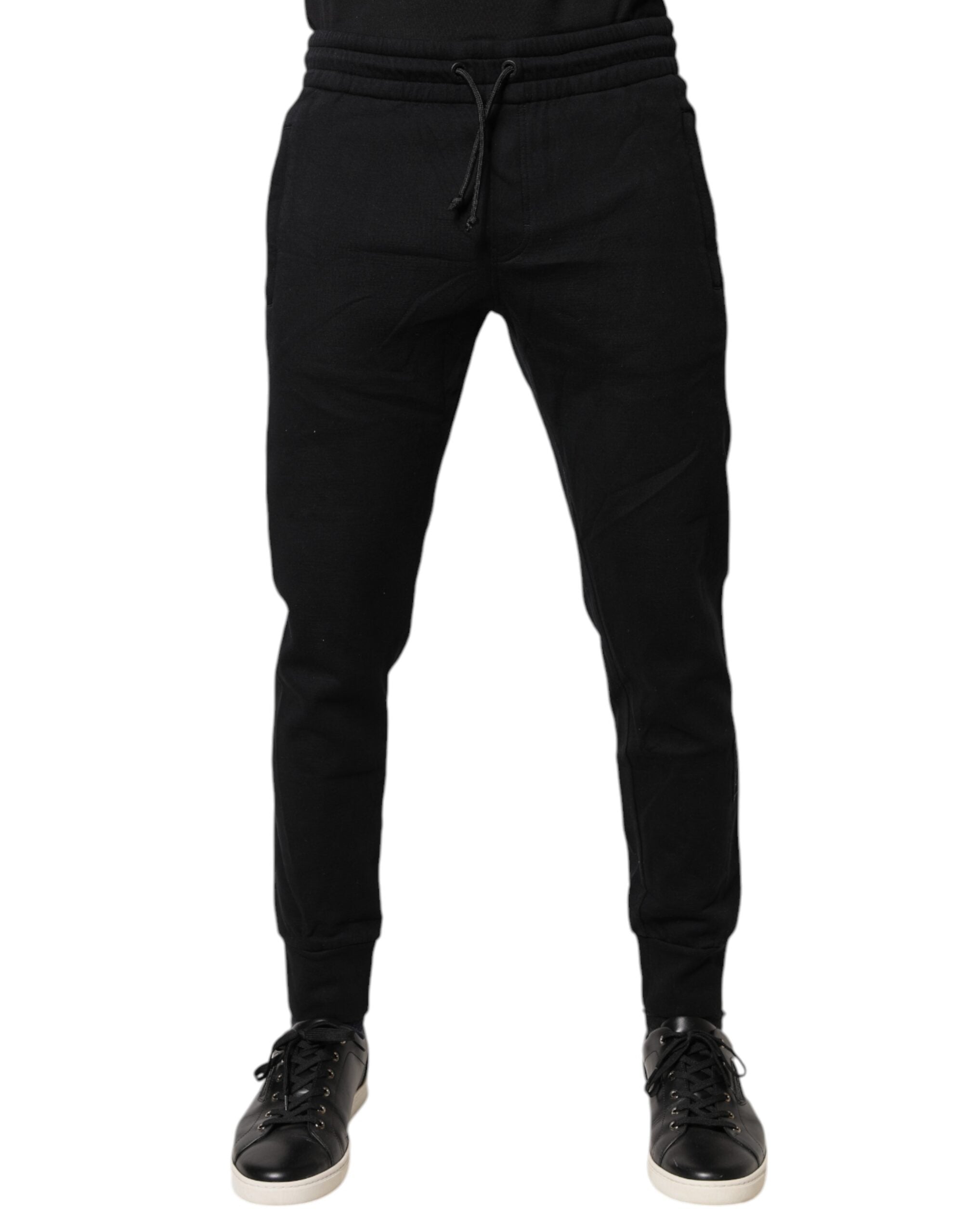 Pantalons de jogging noirs en coton Dolce & Gabbana, style décontracté avec logo discret, vue de face sur un mannequin.