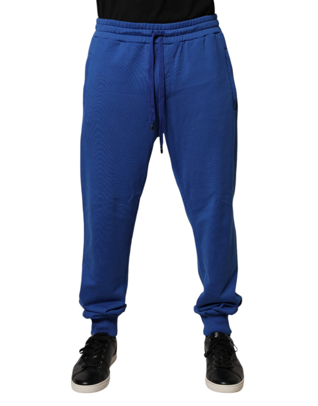 Pantalons joggers en coton bleu de taille moyenne Dolce & Gabbana, vue de face avec ceinture et détails de couture visibles.
