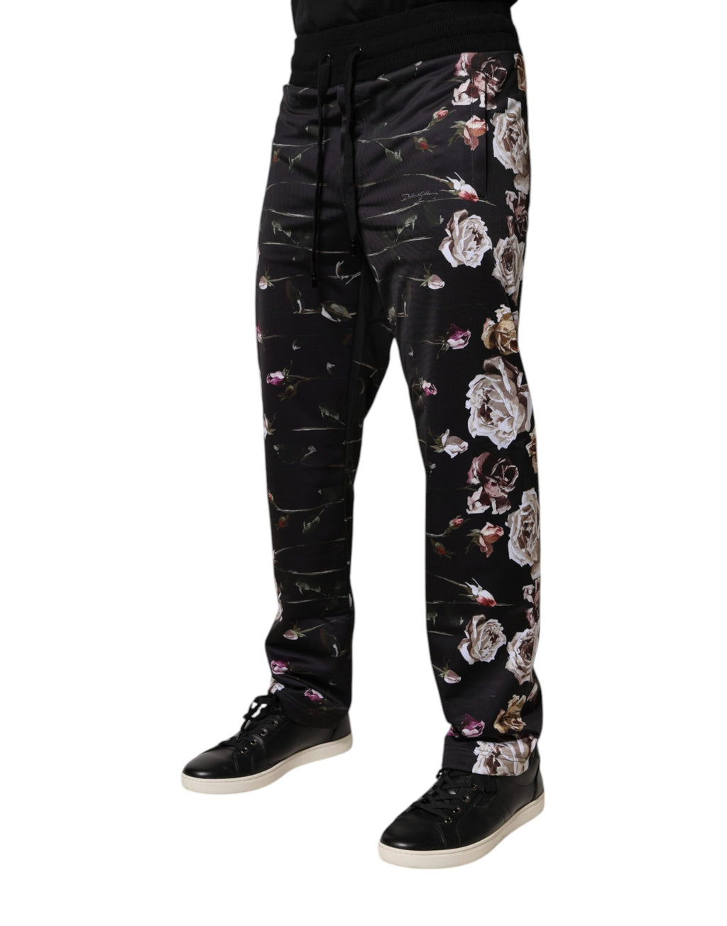 Pantalons jogger en polyester noir à fleurs Dolce & Gabbana, style décontracté et tendance, visibles avec détails floraux.