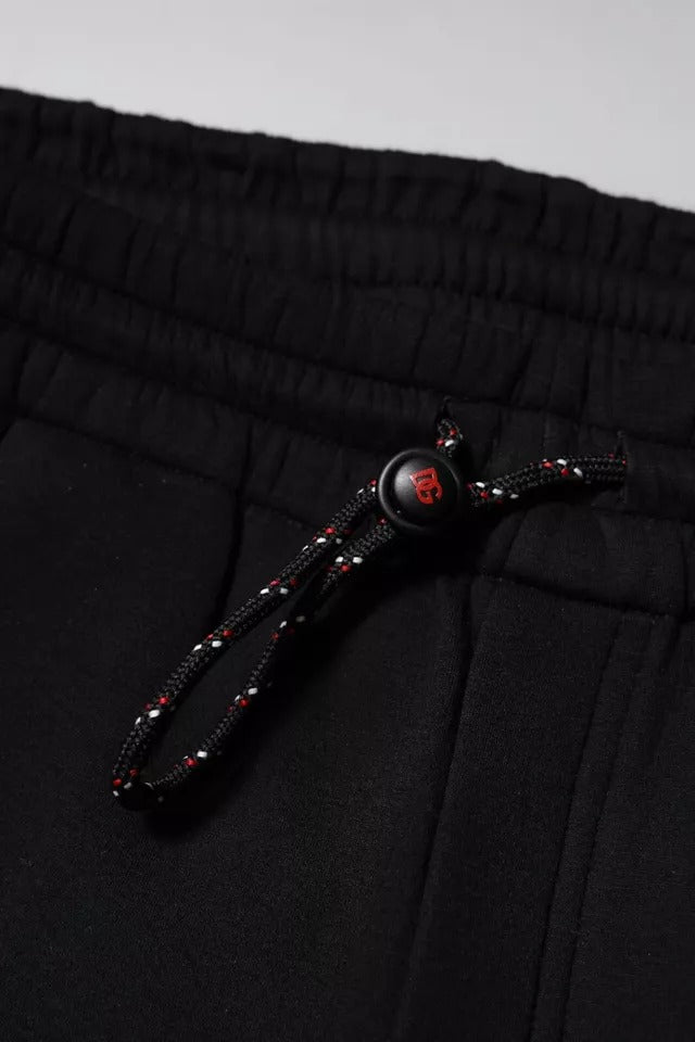 Pantalons joggeurs en coton noir Dolce & Gabbana avec logo brodé, style décontracté et confortable.